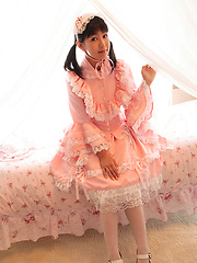Adorable naked asian beauty in takes off her cute pink dress