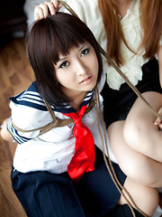 Dimdim Asian in uniform is tied in ropes by another sexy cupcake