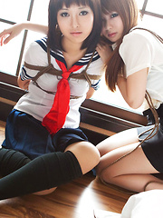 Dimdim Asian in uniform is tied in ropes by another sexy cupcake