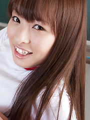Maho Kiruma Asian in sports equipment plays with ball on desk