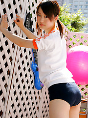 Naoko Sawano Asian in sports outfit plays with balls in garden