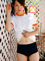 Naoko Sawano Asian in sports outfit plays with balls in garden